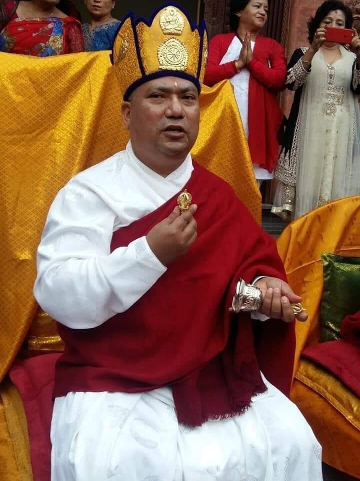 Dr. Naresh Man Bajracharya, seated in ceremonial dress